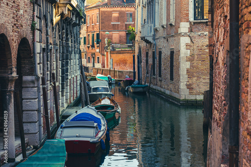 Parked boats by a canal of Venice, Italy.