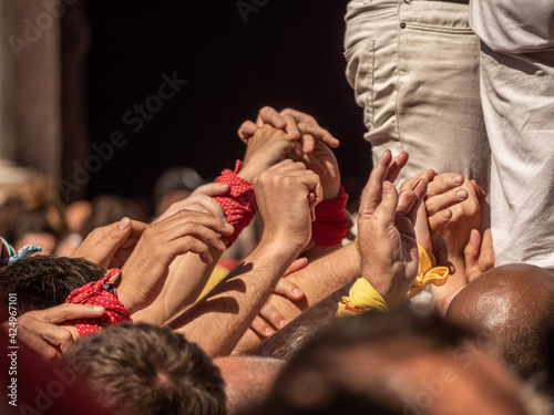 castellers in Catalunya exhibiting at the traditional yearly competition at la Merce celbration on Plaza San Jaume, Barcelona, Spain photo