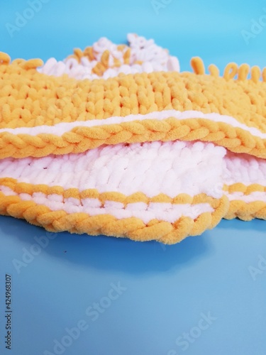 hand-knitted yellow and white plaid knitting, chunky knitting, close-up