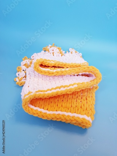 hand-knitted yellow and white plaid knitting, chunky knitting, close-up