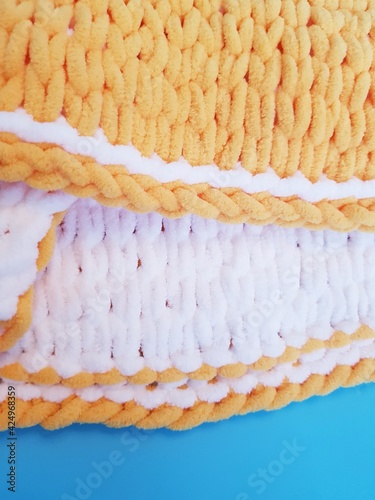 hand-knitted yellow and white plaid, chunky knitting, close-up