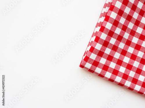 Tablecloth in a red and white cage on a white background. Cloth napkins Service in a cage. Studio photo. Napkin in red and white check, texture, copy space