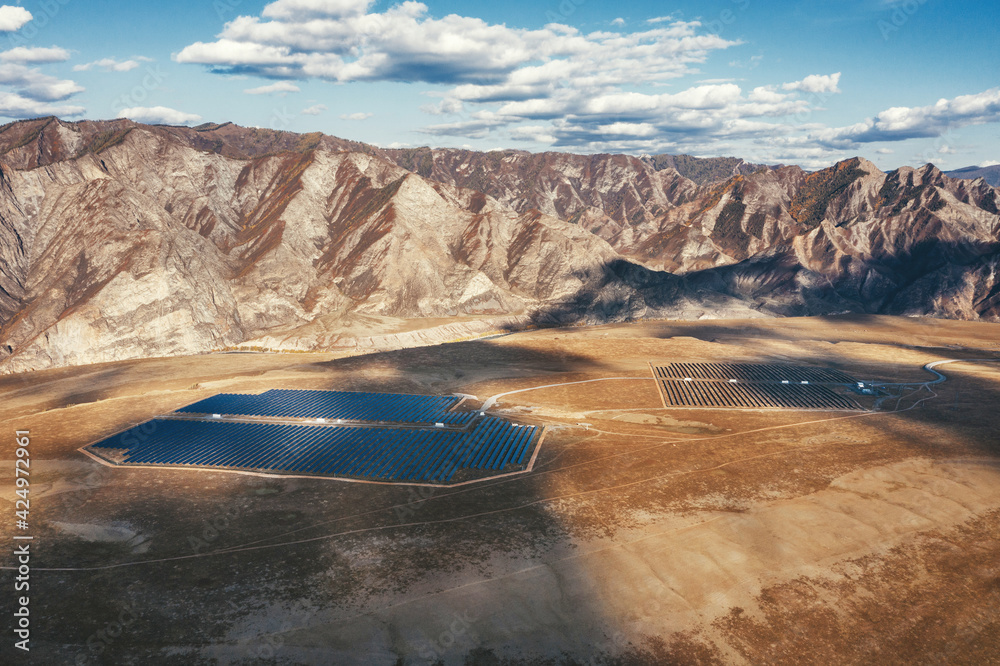 Mountain skyline  drone view, valley with solar panels