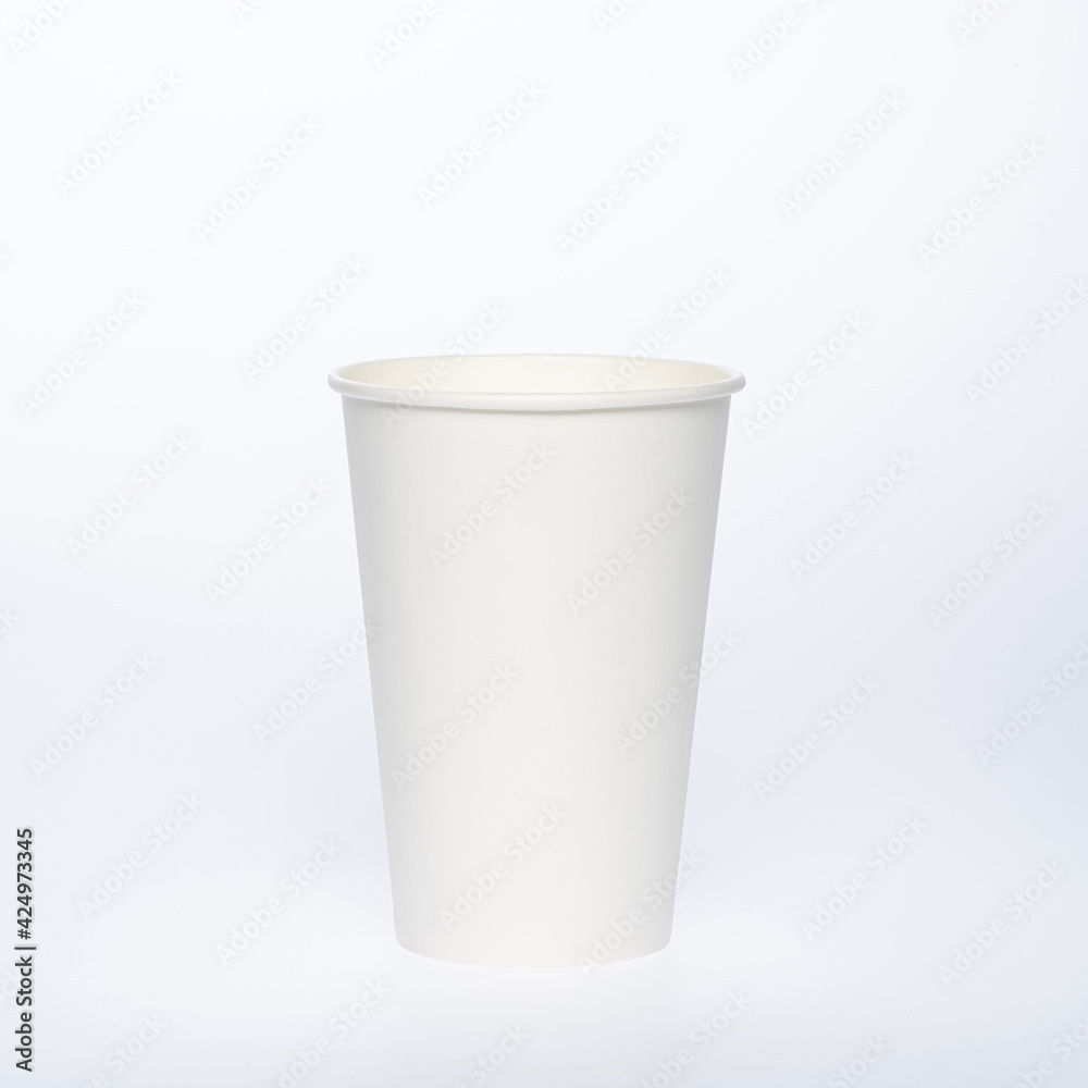 Photo of a disposable white paper cup on a white background. Photo of a coffee cup made of recyclable materials. Empty paper coffee cup. Photo of a disposable white paper cup on a white background. Photo of a coffee cup made of recyclable materials. Empty paper coffee cup.
