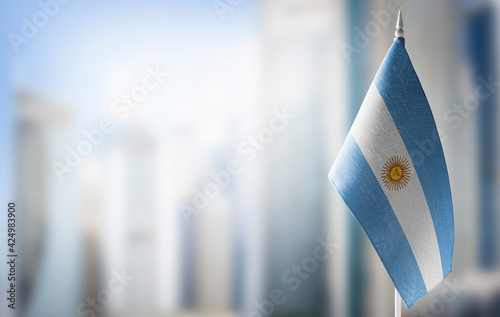 Quadro su tela A small flag of Argentina on the background of a blurred background
