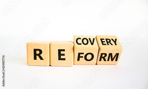 Recovery and reform symbol. Turned cubes and changed the word 'recovery' to 'reform'. Beautiful white background. Business and recovery - reform concept. Copy space.