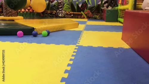 Colorful balls rooling on the floor of kid playground. photo