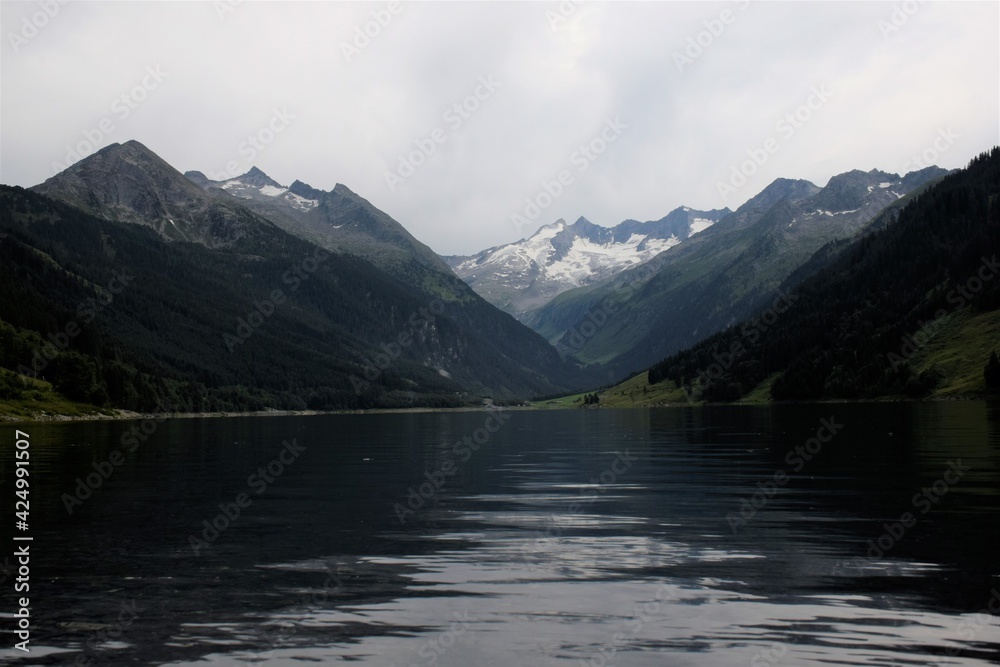 lake in snowy alps mountains