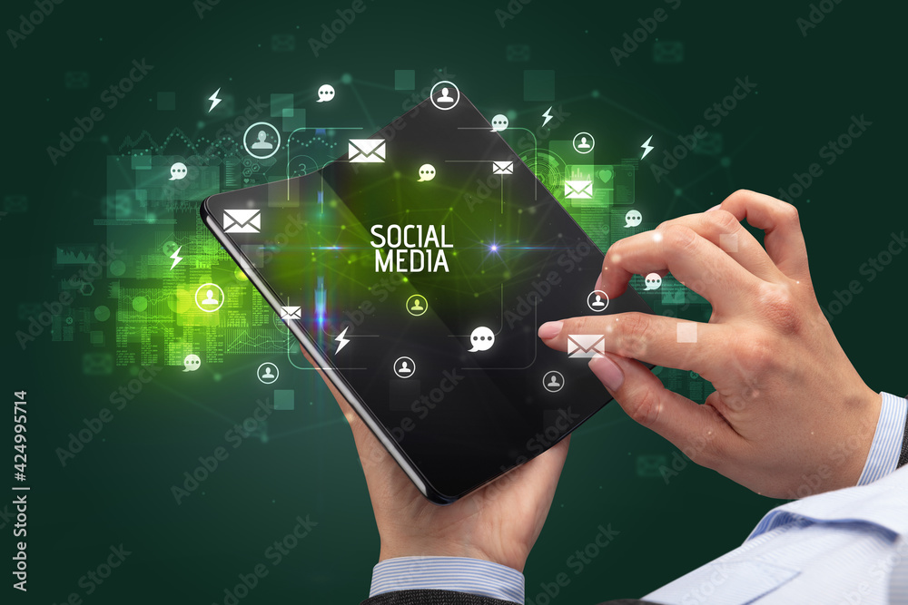 Businessman holding a foldable smartphone, social media concept Businessman holding a foldable smartphone, social media concept