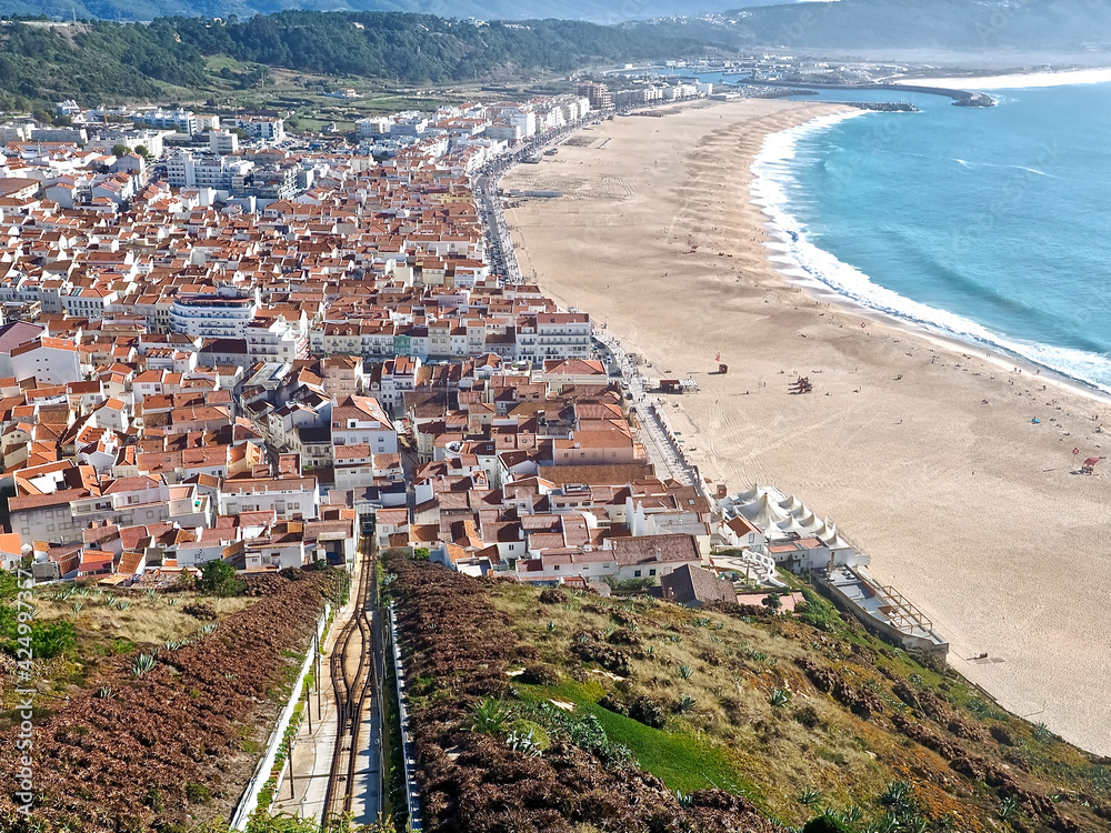 Aerial view of the long beach of Nazare in Portugal with the elevator