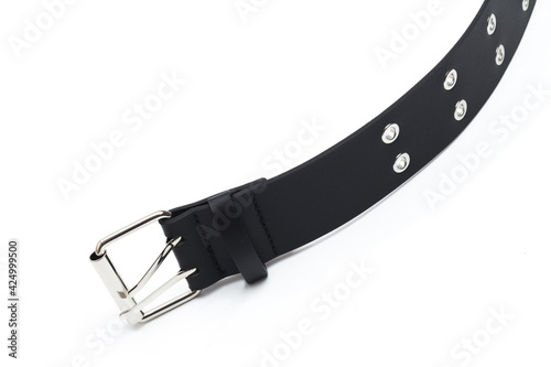 black belt with rivets and buckle rock theme isolated on white background . photo