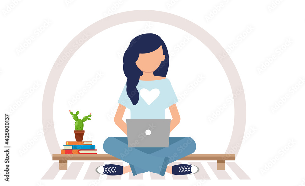 the girl is sitting at the computer