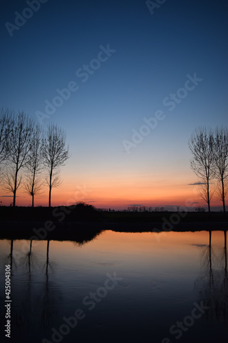 incredible sunset on the Muzza river  lights  colors and reflections surround this breathtaking landscape