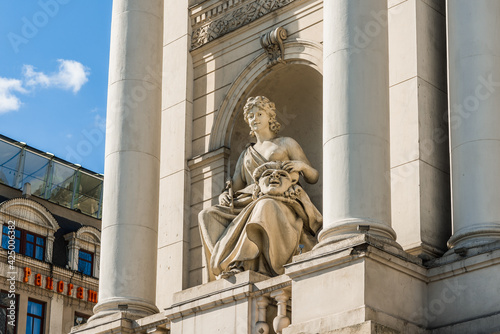 LVIV, UKRAINE - April, 2021: Allegorical statue of a woman on the facade of Lviv Theatre of Opera and Ballet. photo