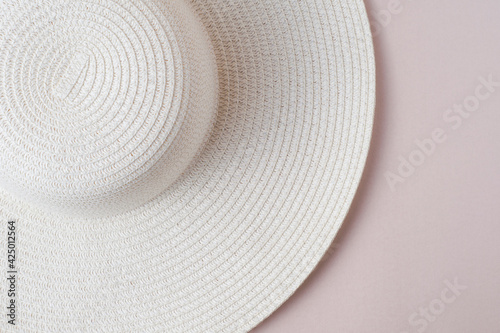 A large white beach lady's hat on a pastel beige background. The concept of vacation, vacation, travel, sales, black Friday.