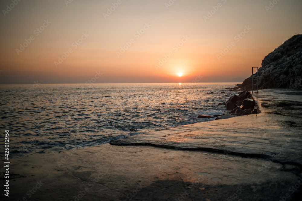Beautiful sunset on the background of the sea. Sunset seascape. Beautiful view of the sunset sea