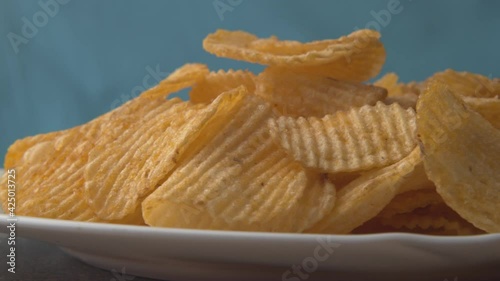 Potato chips yellow macro background. Unhealthy junk food closeup rotating.