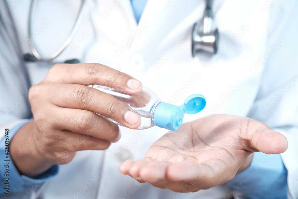 close up of doctor hand using sanitizer gel close up of doctor hand using sanitizer gel