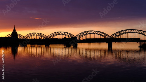 Dawn over the Daugava, the sun illuminates the railway bridge in Riga © IHAR