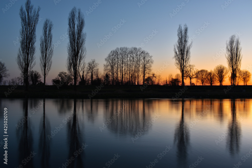beautiful sunset on the river, colors, lights and reflections surround this wonderful countryside landscape beautiful sunset on the river, colors, lights and reflections surround this wonderful countryside landscape