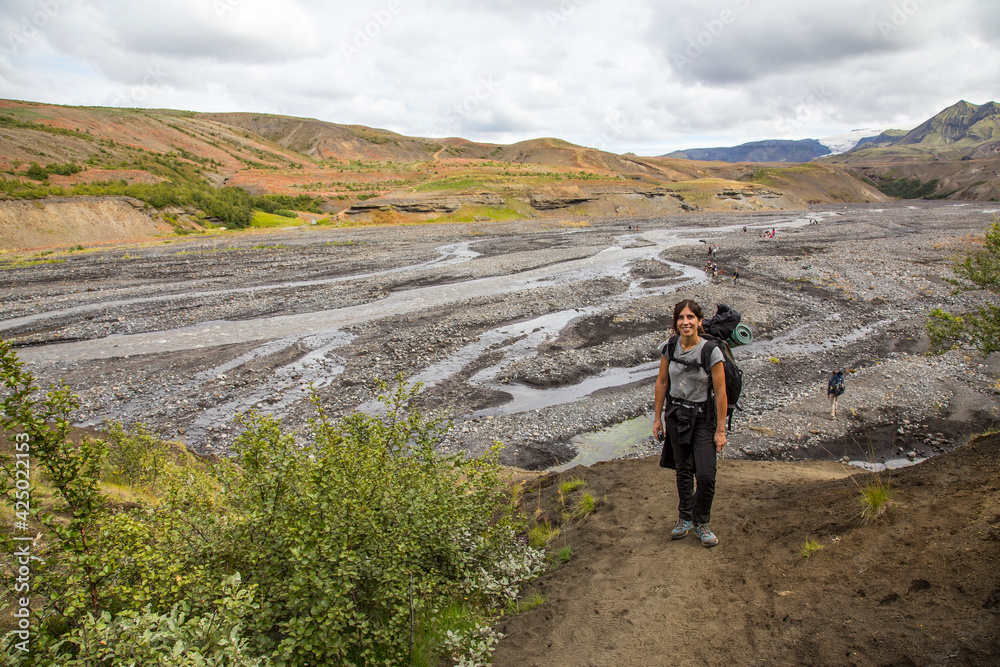 A young woman starting the trekking trail from Landmannalaugar, Iceland