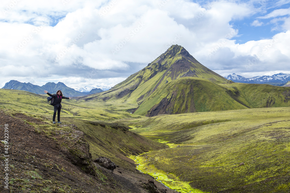Landmannalaugar, Iceland »; August 2017: A young woman in the incredible landscape of the Landmannalaugar trekking and a mountain in the background.