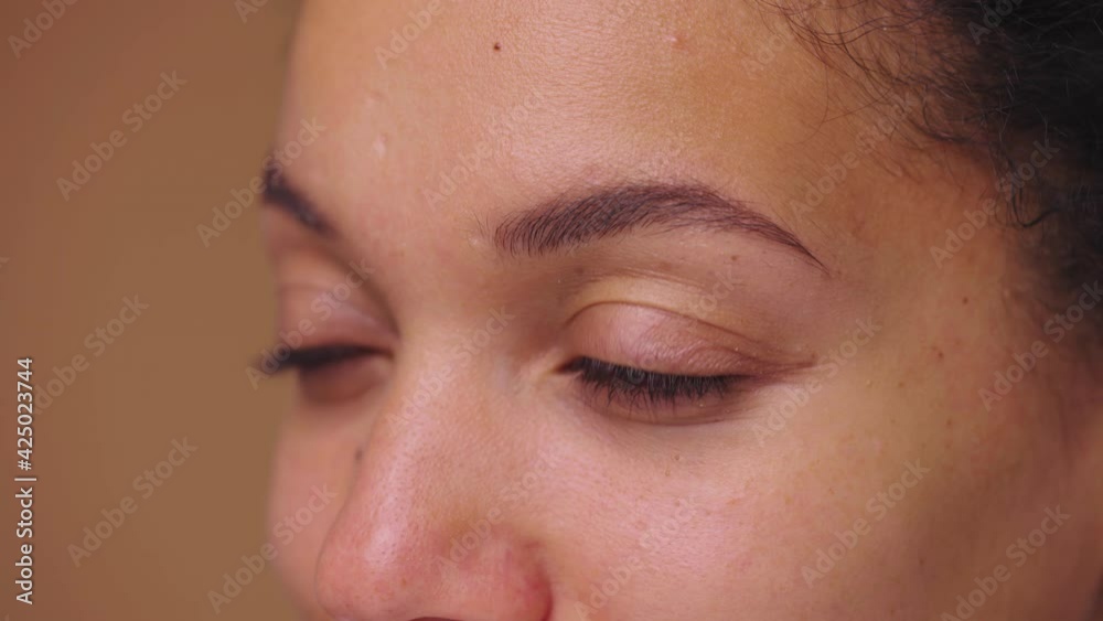 Brown female eyes look seriously to the side. African American woman eyes with natural beauty. Close up macro portrait with perfect clean and smooth skin. Slow motion ready, 4K at 59.94fps. Brown female eyes look seriously to the side. African American woman eyes with natural beauty. Close up macro portrait with perfect clean and smooth skin. Slow motion ready, 4K at 59.94fps.