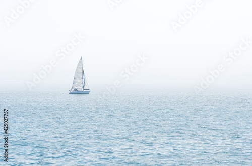 sailboat on the sea in an foggy day © Orhan Çam