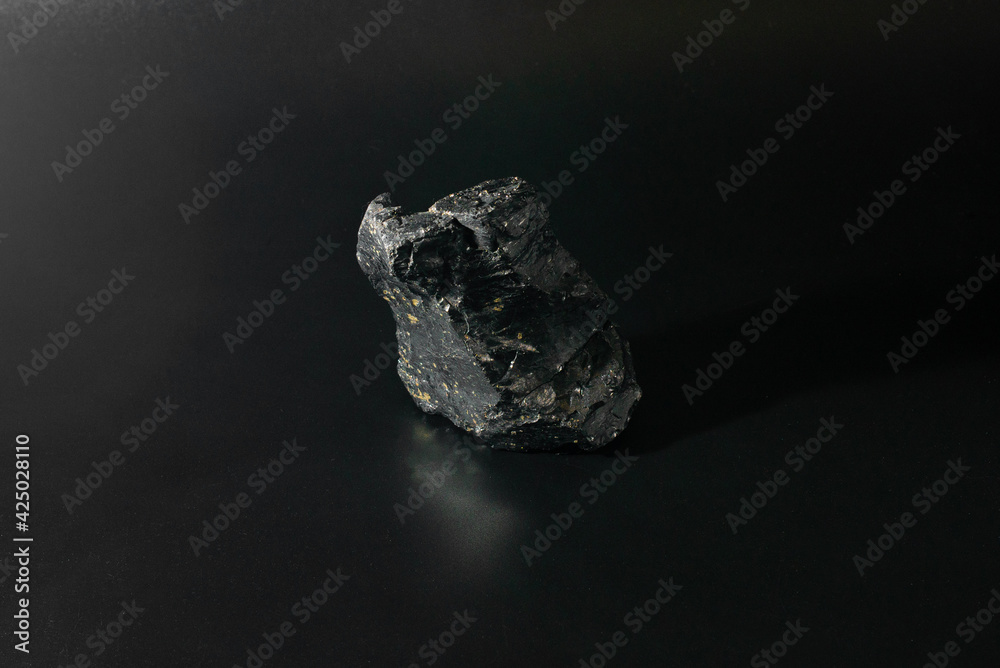 shard of coal on a black background, close-up