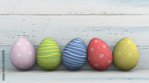 Colourful Easter eggs isolated against whitish and bluish wooden background. 3D Render. Copy space available.
