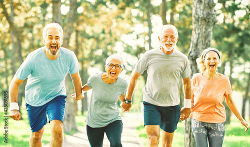 Fototapeta Naklejka Na Ścianę i Meble -  outdoor senior fitness woman man lifestyle active sport exercise healthy fit runner running jogging elderly mature gray hair