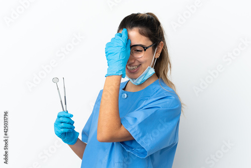Young woman dentist holding tools isolated on white background laughing