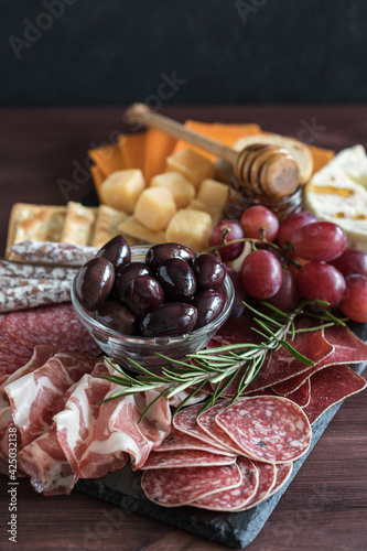 Charcuterie meat cheese board on slate board