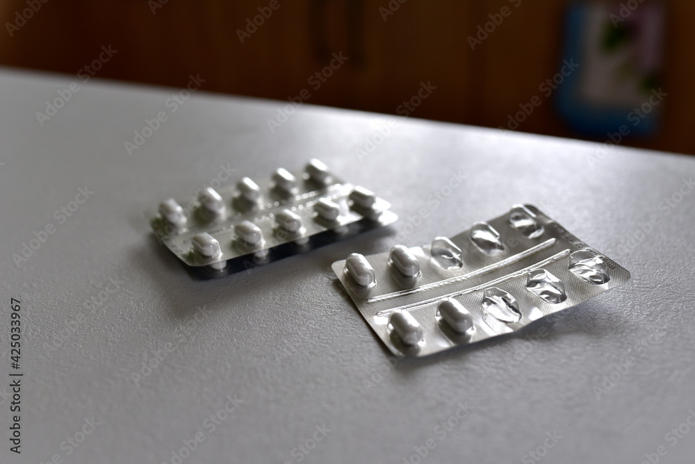 Pills in packpage on table. Medicine grade pharmaceutical tablets. Medical pill for maintaining and improving health. Antidepressant addiction and depression concept Pills in packpage on table. Medicine grade pharmaceutical tablets. Medical pill for maintaining and improving health. Antidepressant addiction and depression concept