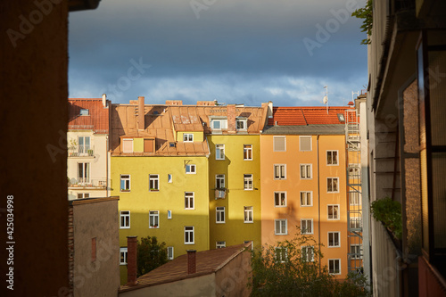 Sunlit houses in a courtyard. Blue sky. Eye level shot. Ludwig suburb/Munich. Germany. Here you have peace and quiet.