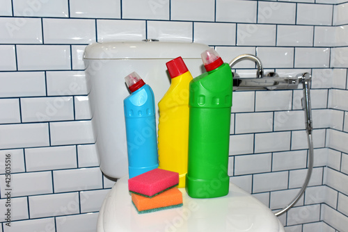 Detergent bottles and sponge for cleaning the toilet in the bathroom in home. Detergents bottles and kitchen sponges. Household Toilet Cleaners. Anti-bacterial liquids for ​house clean and dishwasher