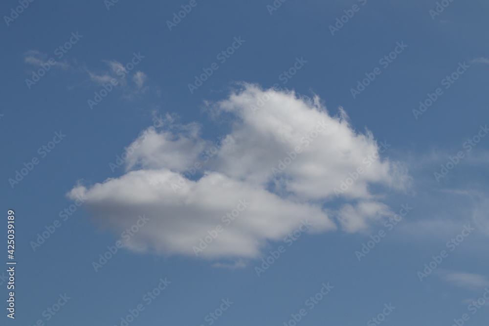 Blue sky texture with clouds. Clouds in the blue sky during the day. 