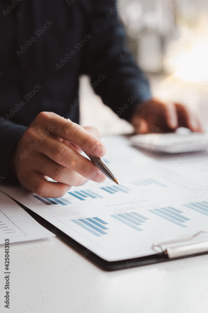 Business people or accountants are analyzing graphs on finance, investment, graph chart business strategy ideas, data analysis technology. Business people or accountants are analyzing graphs on finance, investment, graph chart business strategy ideas, data analysis technology.