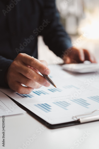 Business people or accountants are analyzing graphs on finance, investment, graph chart business strategy ideas, data analysis technology.