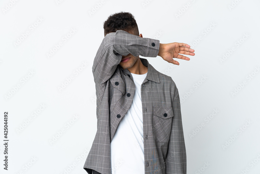 Young brazilian man isolated on white background covering eyes by hands Young brazilian man isolated on white background covering eyes by hands