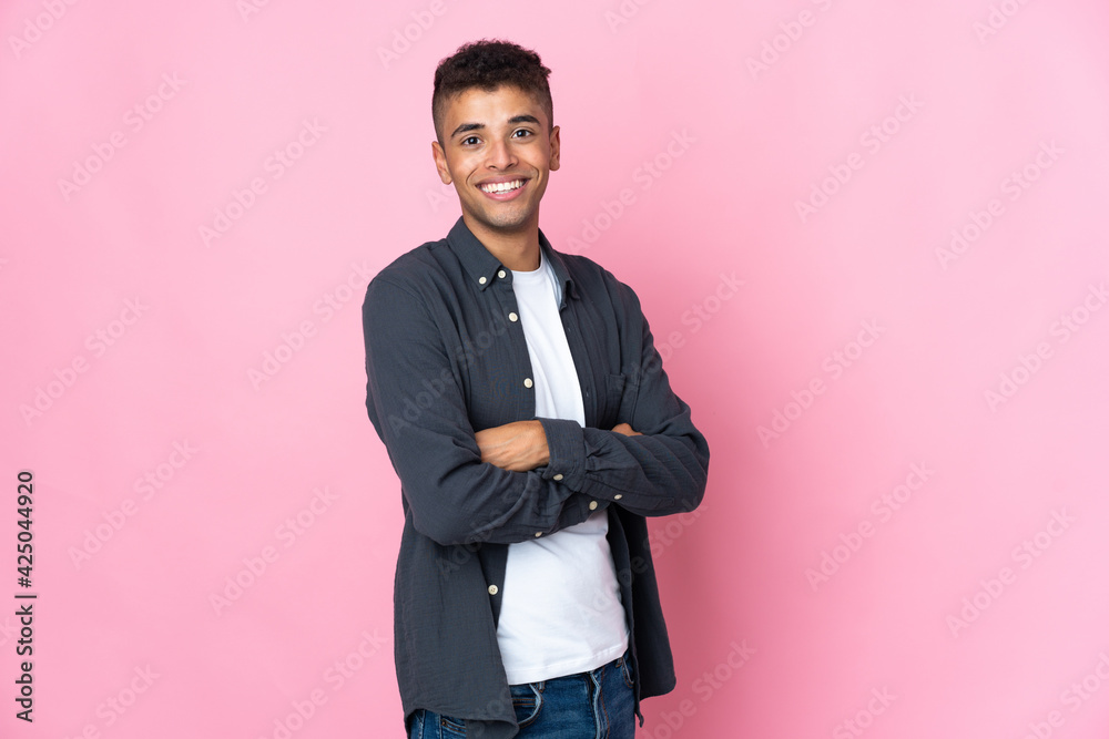 Young Brazilian man isolated on pink background looking to the side and smiling Young Brazilian man isolated on pink background looking to the side and smiling
