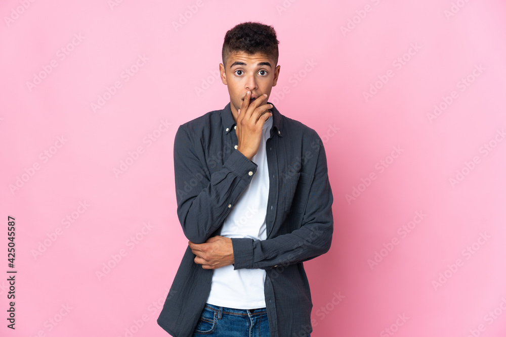Young Brazilian man isolated on pink background surprised and shocked while looking right Young Brazilian man isolated on pink background surprised and shocked while looking right