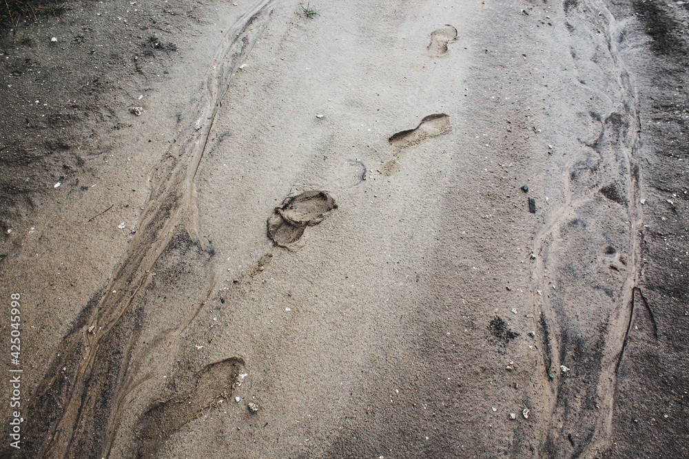 traces of rubber boots on the road after the rain