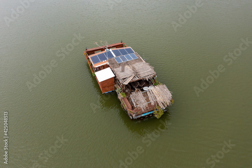 Self Sufficient floating house with solar panels, Aerial view.  © STOCKSTUDIO