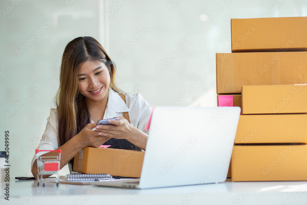 Portrait of Starting small businesses SME owners female entrepreneurs working, box and check online orders to prepare to pack the boxes, sell to customers, sme business ideas online. Portrait of Starting small businesses SME owners female entrepreneurs working, box and check online orders to prepare to pack the boxes, sell to customers, sme business ideas online.