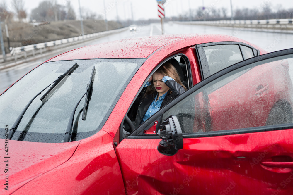 Obraz premium Young pretty scared woman in the car. Injured woman feeling bad after having a car crash