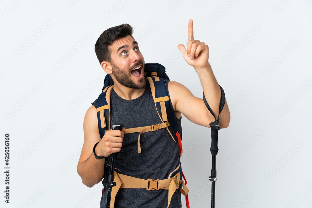 Young mountaineer man with a big backpack and trekking poles isolated on white background pointing with the index finger a great idea Young mountaineer man with a big backpack and trekking poles isolated on white background pointing with the index finger a great idea