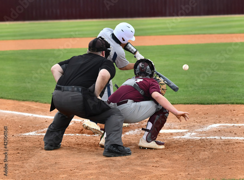 Photography Action photo of athletic high school baseball player making an amazing play duri