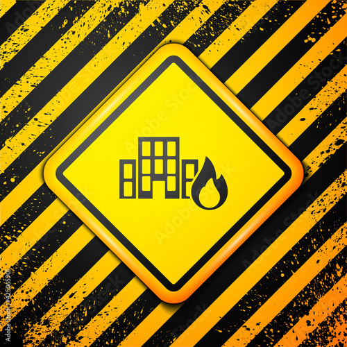 Black Fire in burning buildings on city street icon isolated on yellow background. Destroyed city on fire. Warning sign. Vector