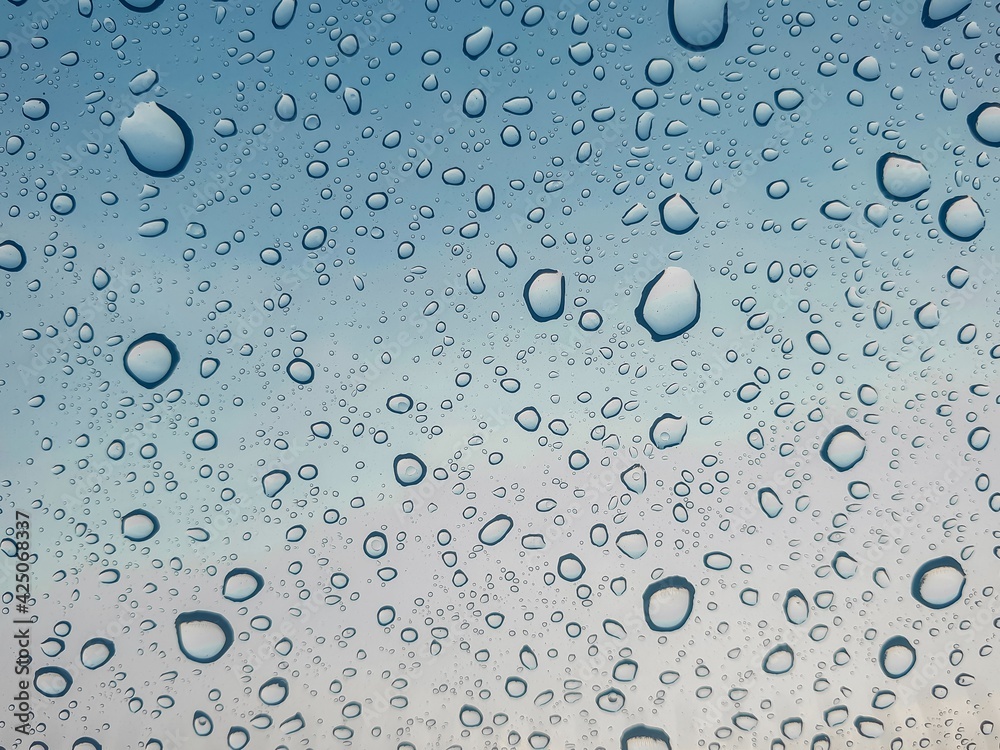 Rainy day background with copy space. Drops of water and glass is frosted on the windshield. 